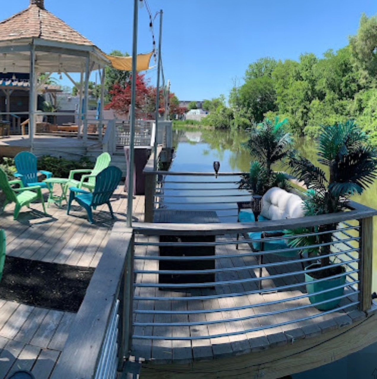 Riverhouse waterfront deck with Adirondack chairs along the Clinton River
