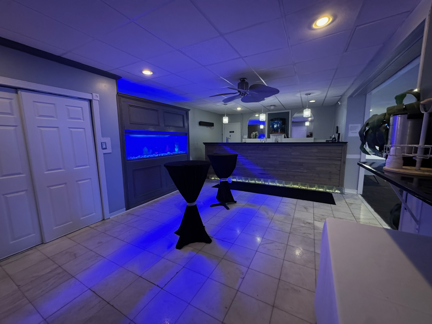 Cocktail lounge with blue ambient lighting and bar area